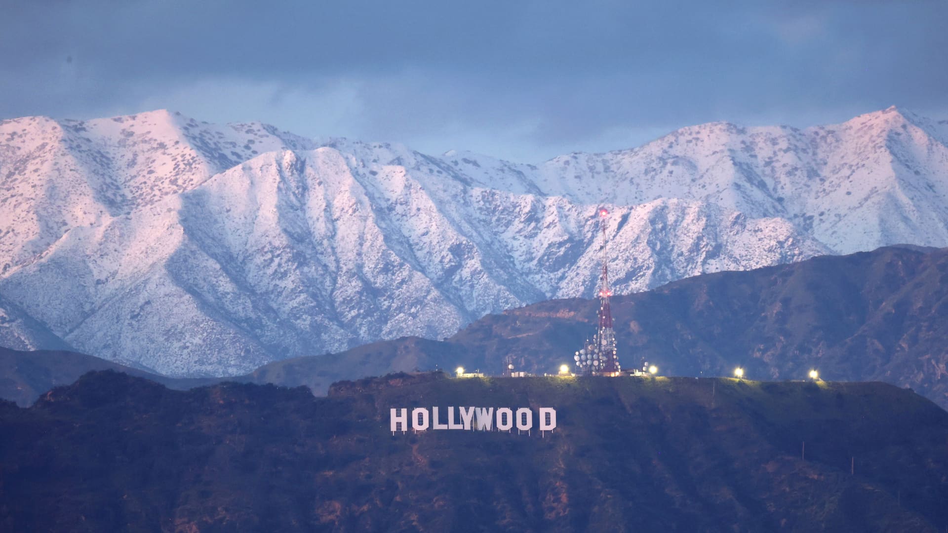 The Hollywood sign stands in front of snow-covered mountains after another winter storm hit Southern California on March 01, 2023 in Los Angeles, California.