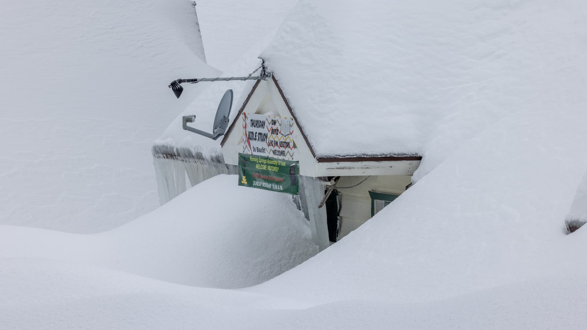 A church is shown buried under snow in the San Bernardino Mountains area where residents continue to be trapped on March 1, 2023 in Running Springs, California.