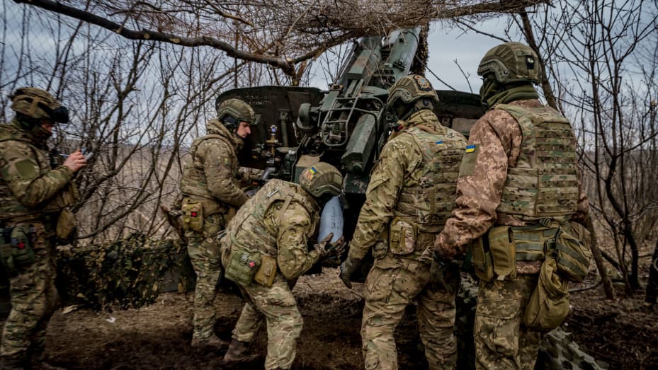 Ukrainian servicemen load a 152 mm shell into a Msta-B howitzer to fire toward Russian positions, near the front-line town of Bakhmut on March 2, 2023.