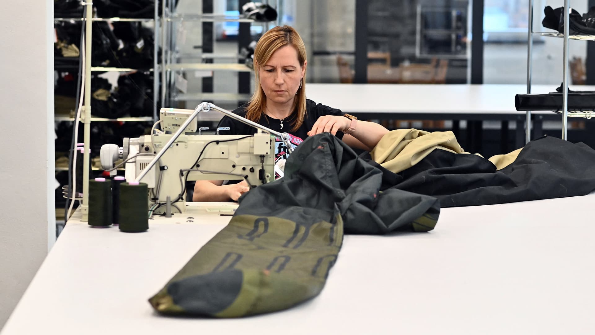 A worker sews the material for an inflatable decoy of a military vehicle in Decin, Czech Republic on March 6, 2023. 