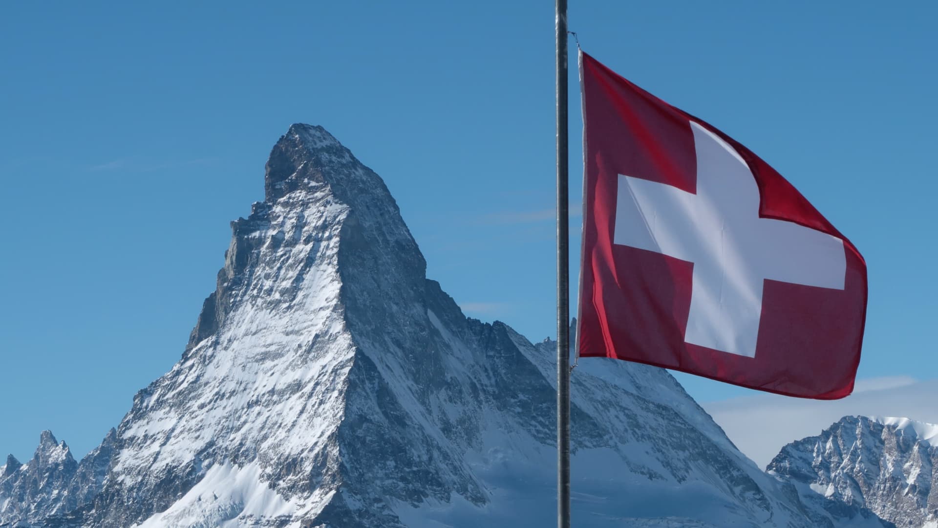 A Swiss flag flies near Matterhorn mountain on January 7, 2022 near Zermatt, Switzerland.