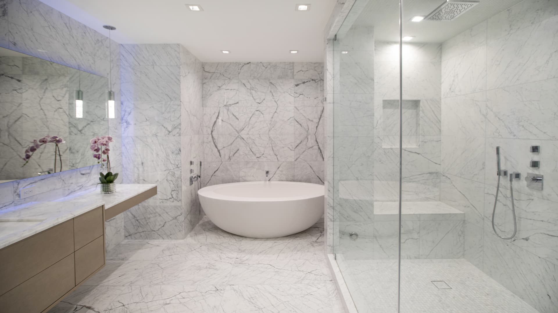 The marble-clad primary bath and steam shower.