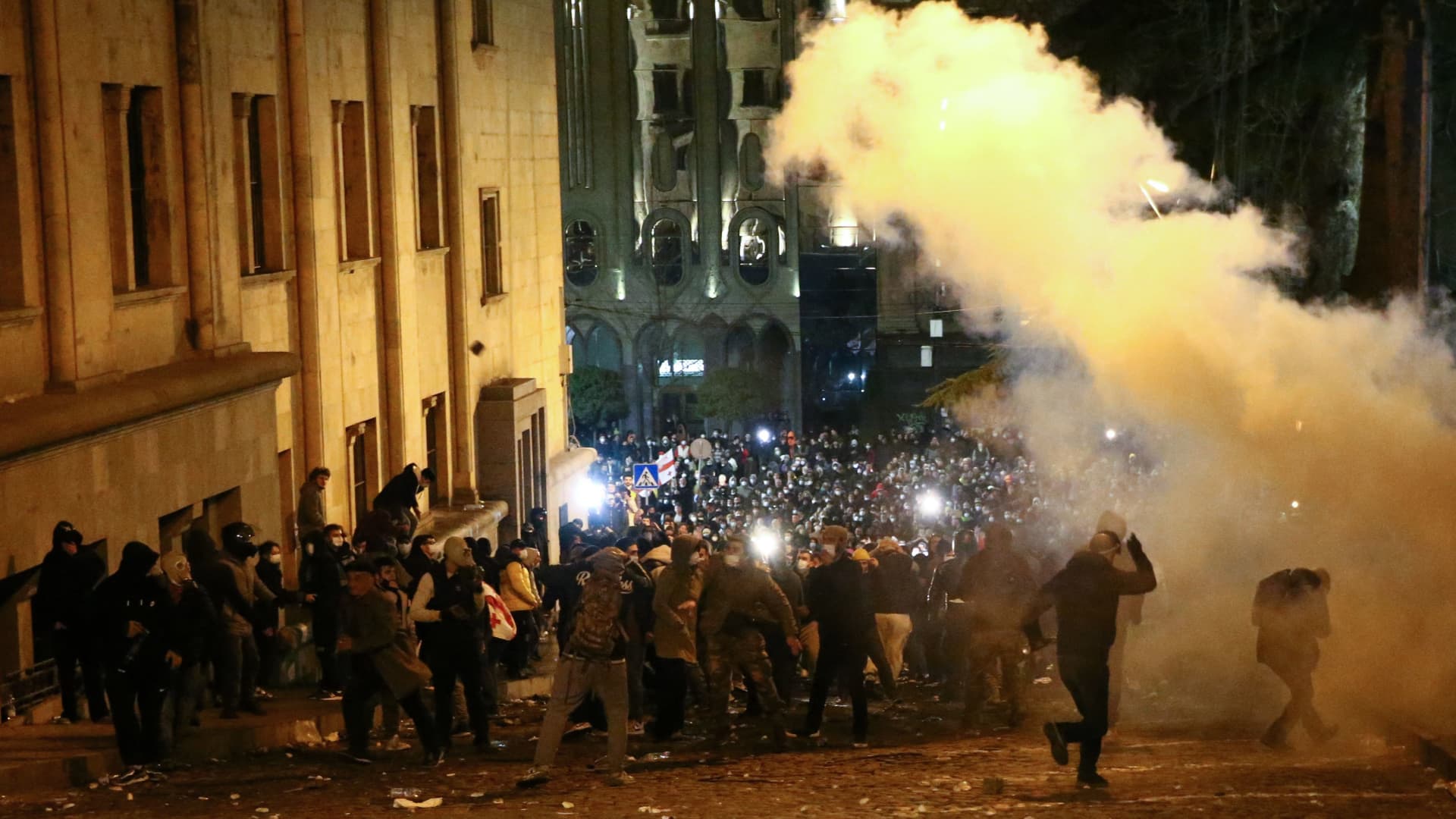 Protesters clash with riot police near the Georgian parliament in Tbilisi on March 7, 2023.