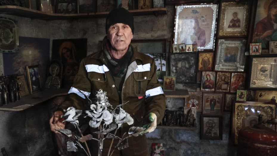 Viktor Mikhalev shows roses transformed from weapons and ammunition into flowers of war standing in a workshop in his house in Donetsk, Russian-controlled Donetsk region, eastern Ukraine, Saturday, March 4, 2023. Mikhalev, trained as a welder, lives and works in a house whose fence and door are decorated with forged flowers and grapes.