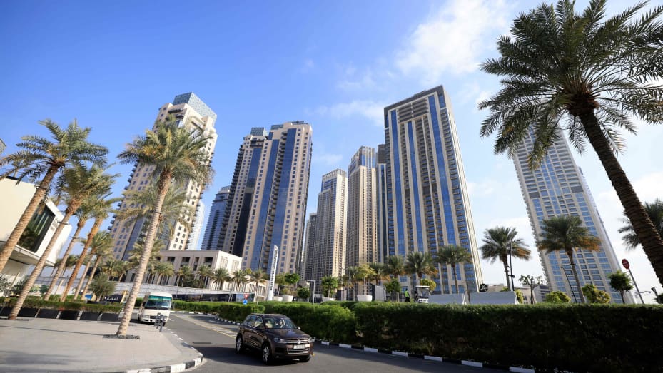 Cars drive along a street in front of high-rise buildings in Dubai, on February 18, 2023. Dubai saw record real estate transactions in 2022, largely due to an influx of wealthy investors, especially from Russia.