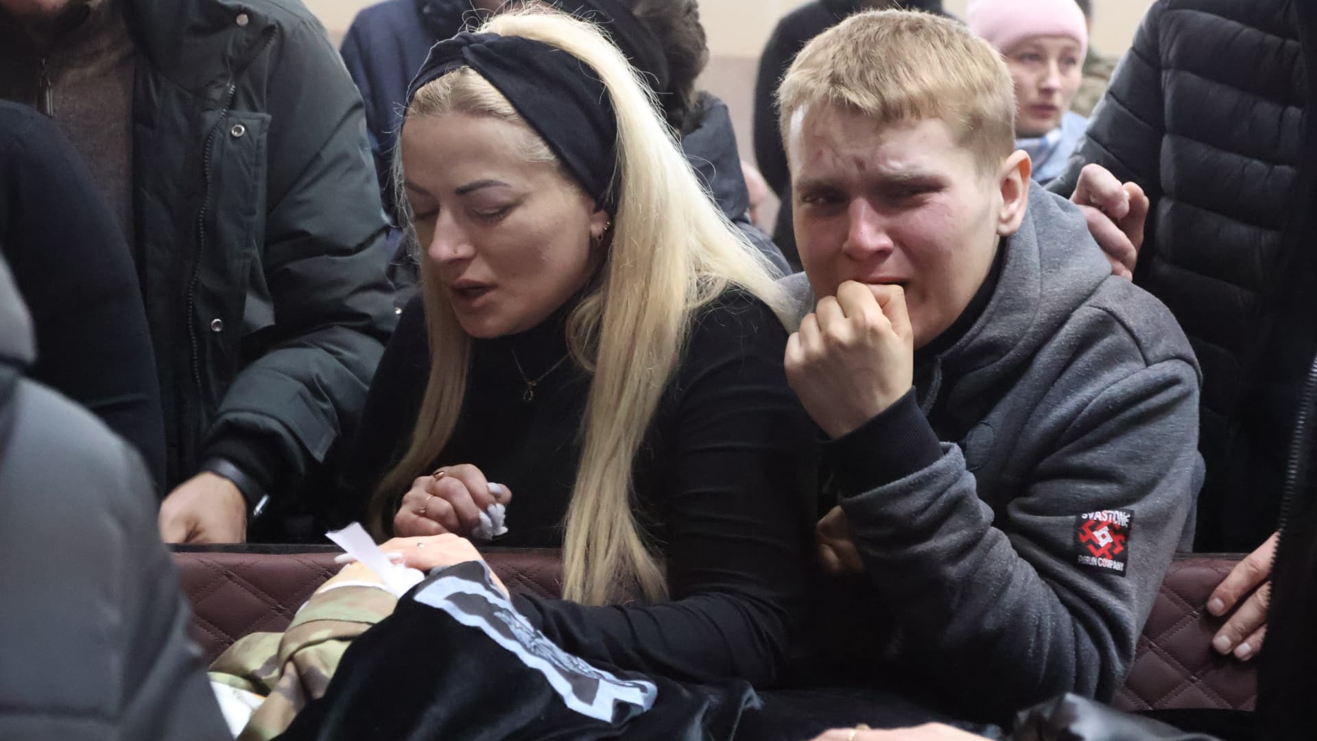 The family mourns near the coffin during the farewell ceremony for the Hero of Ukraine Dmytro Kotsiubailo “Da Vinci” on March 9, 2023 in Bovshiv, Ivano-Frankivsk Oblast, Ukraine. 