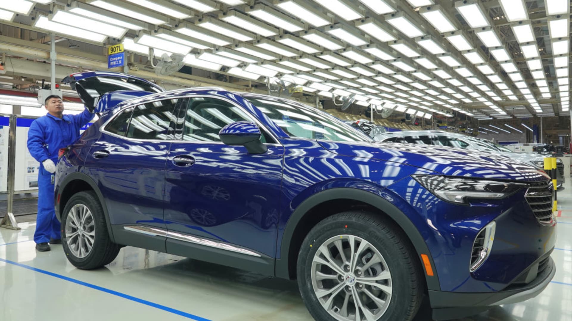 Employees work on Buick Envision SUVs at General Motors' Dong Yue assembly plant, officially known as SAIC-GM Dong Yue Motors Co., Ltd., on Nov. 17, 2022, in Yantai, Shandong Province of China.
