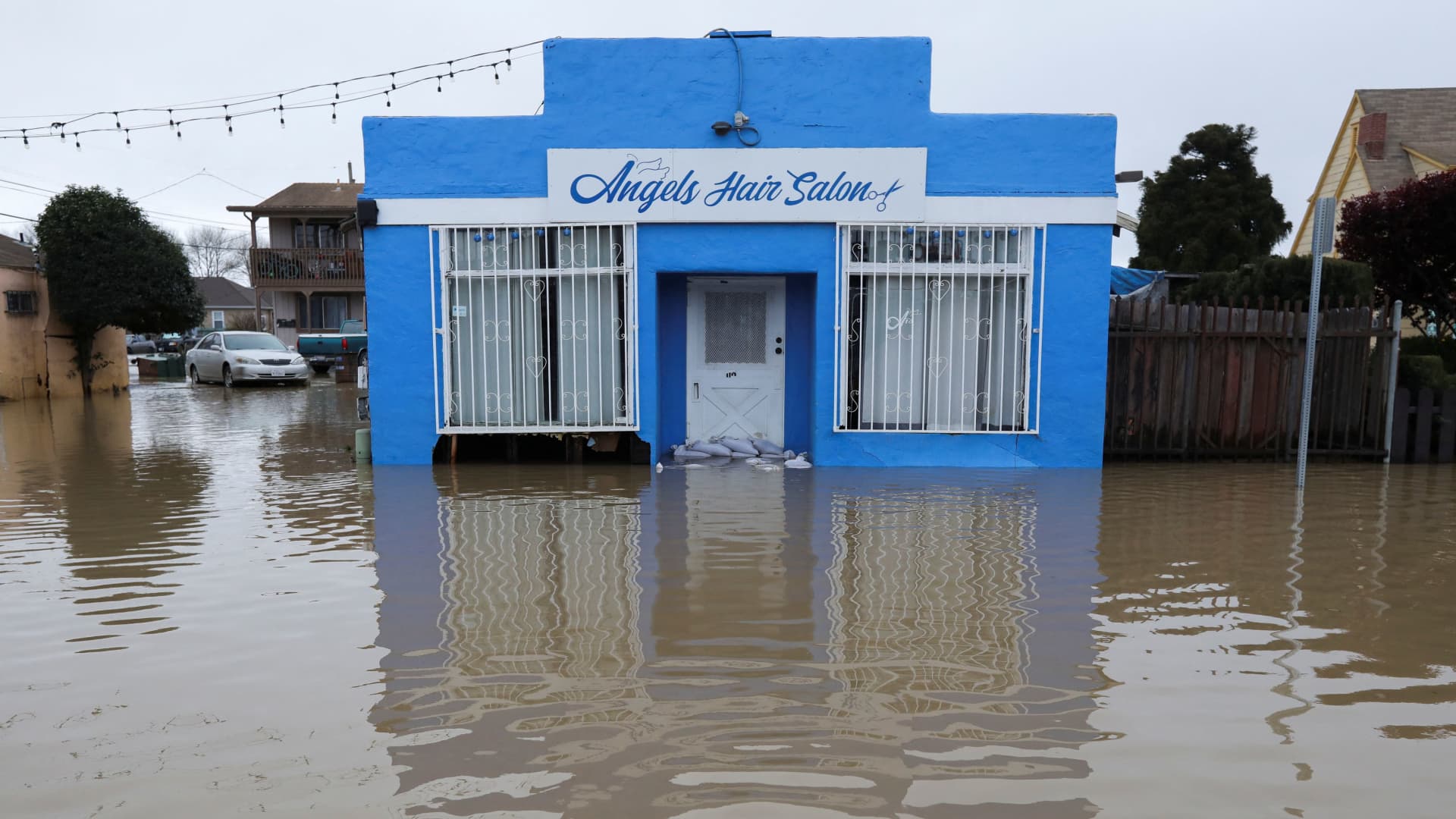 Angels Hair Salon with a damaged facade sits surrounded by floodwaters from the Pajaro River in Pajaro, California, U.S. March 13, 2023. 