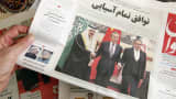 A man in Tehran holds a local newspaper reporting on its front page the China-brokered deal between Iran and Saudi Arabia to restore ties, signed in Beijing the previous day, on March, 11 2023.
