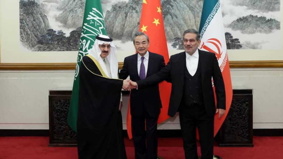 Iran's top security official Ali Shamkhani (R), Chinese Foreign Minister Wang Yi (C) and Musaid Al Aiban, the Saudi Arabia's national security adviser pose for a photo after Iran and Saudi Arabia have agreed to resume bilateral diplomatic ties after several days of deliberations between top security officials of the