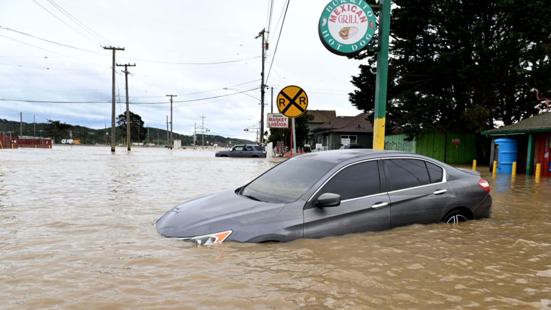 Watsonville, California March 14, 2023-Stranded cars sit along Salinas Rd. in Pajaro Tuesday after a pair of powerful storms blew through the area causing mass flooding.