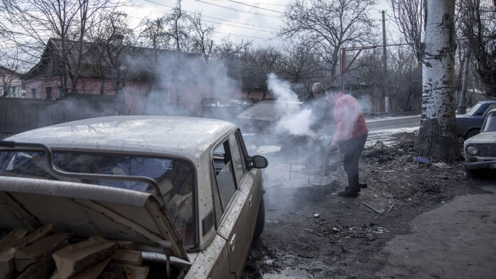 Locals gather next to a grocery shop as grill meat on the street on east Chasiv Yar nearby Bakhmut frontline as fighting continues between Ukrainian forces and Russian troops for control of the city in Donetsk Oblast Ukraine on March 12, 2023.