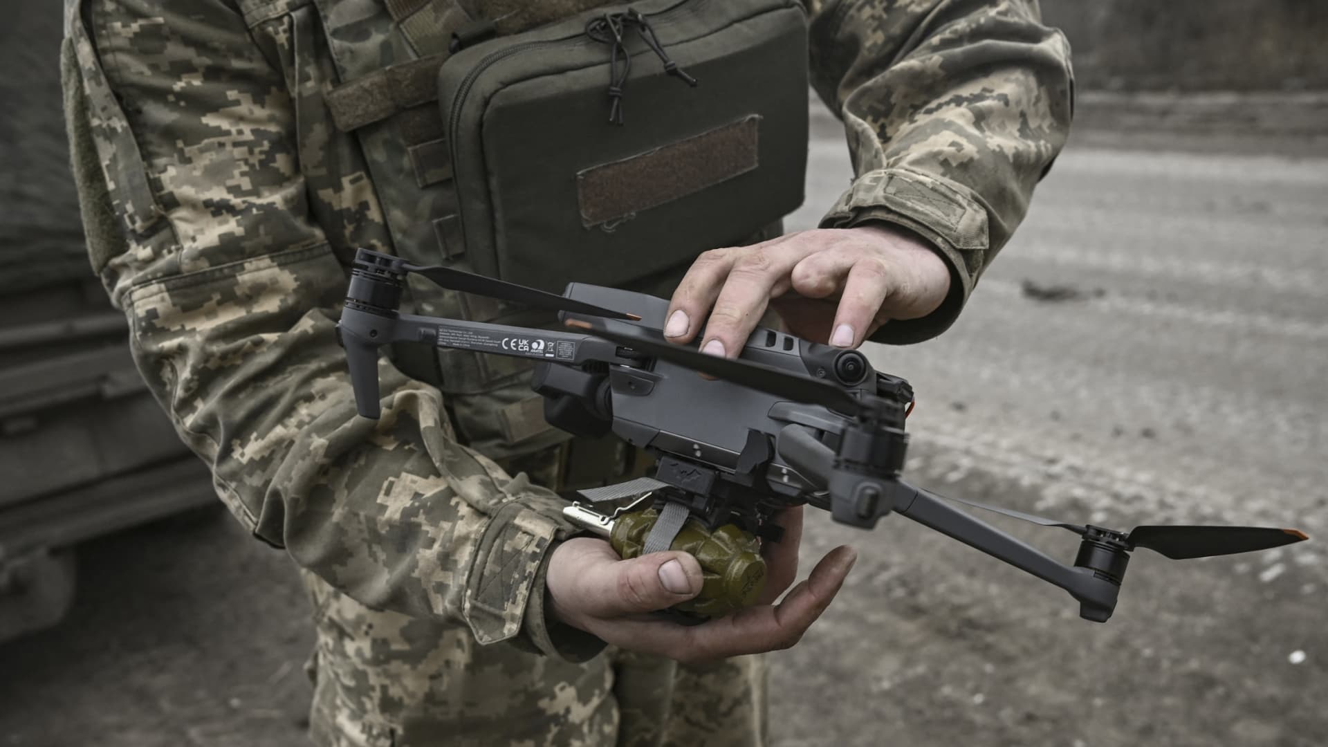 An Ukrainian serviceman attaches a hand grenade on a drone to use in an attack, near Bachmut, in the region of Donbas, on March 15, 2023. 