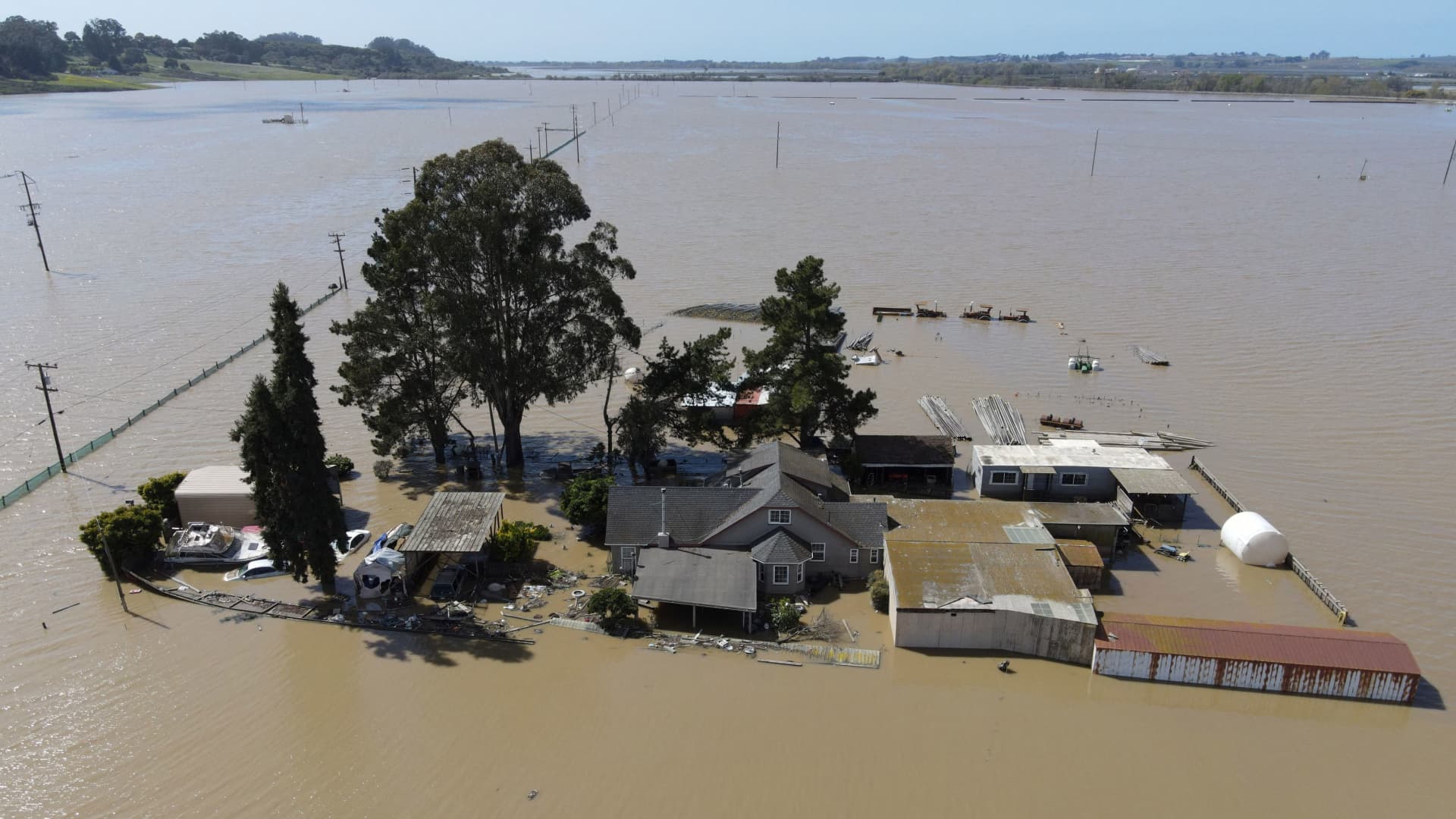 A home is surrounded by floodwaters from the Pajaro River after days of heavy rain in Pajaro, California, March 15, 2023.