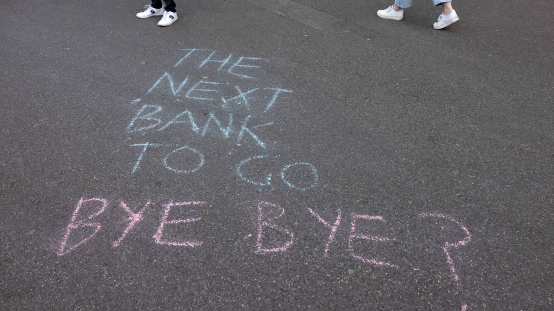 A slogan is written on the sidewalk in front of the global headquarters of Swiss bank Credit Suisse the day after its shares dropped approximately 30% on March 16, 2023 in Zurich, Switzerland.