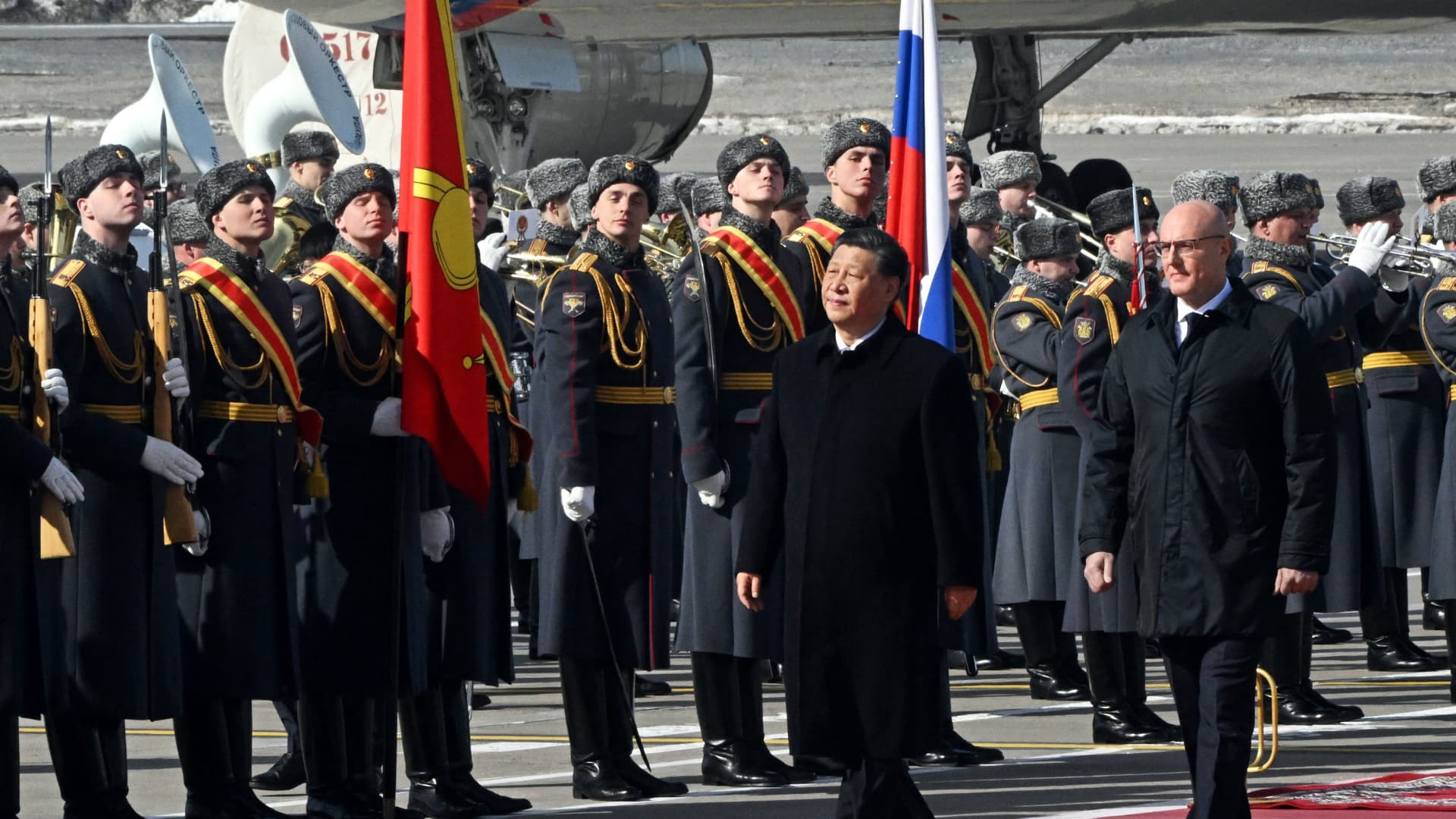 China's President Xi Jinping, accompanied by Russian Deputy Prime Minister Dmitry Chernyshenko, walks past honour guards during a welcoming ceremony at Moscow's Vnukovo airport on March 20, 2023.