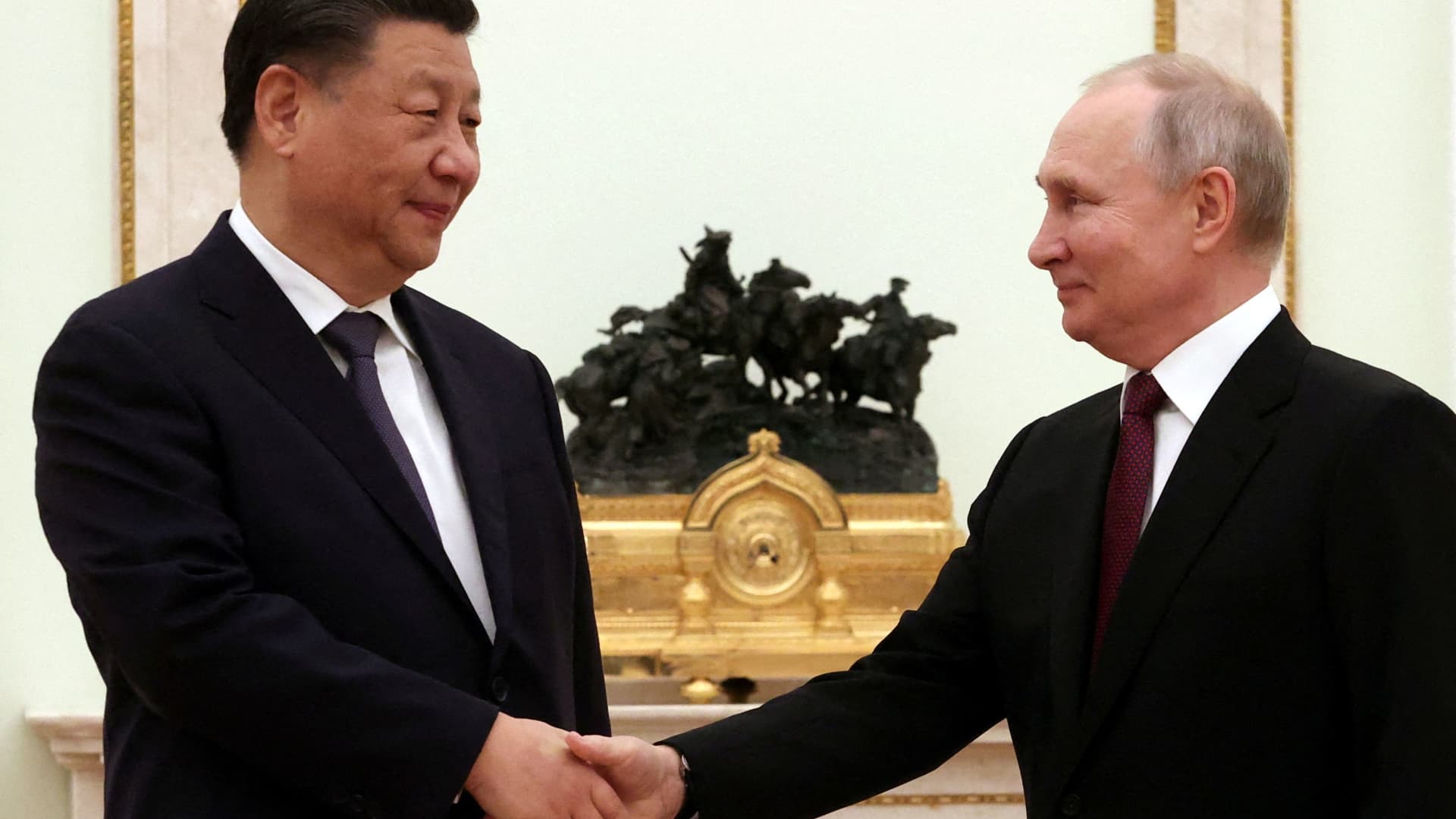 Russian President Vladimir Putin shakes with Chinese counterpart Xi Jinping during a meeting at the Kremlin in Moscow on March 20, 2023. Xi said he's invited Putin to visit China this year, Russian news agencies reported Tuesday.
