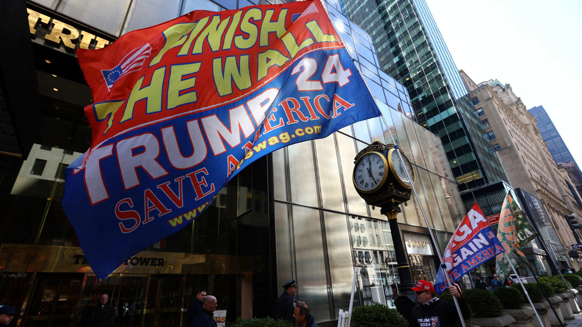 A man who identified himself as Don Cini, a supporter of former U.S. President Donald Trump, flies Trump campaign flags outside Trump Tower in midtown Manhattan in New York City, New York, March 20, 2023.