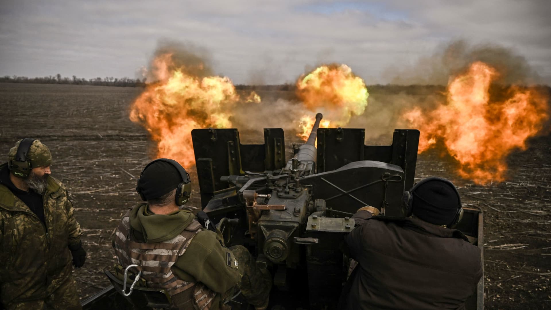 Ukrainian servicemen fire with a S60 anti-aircraft gun at Russian positions near Bachmut on March 20, 2023, amid the Russian invasion of Ukraine.