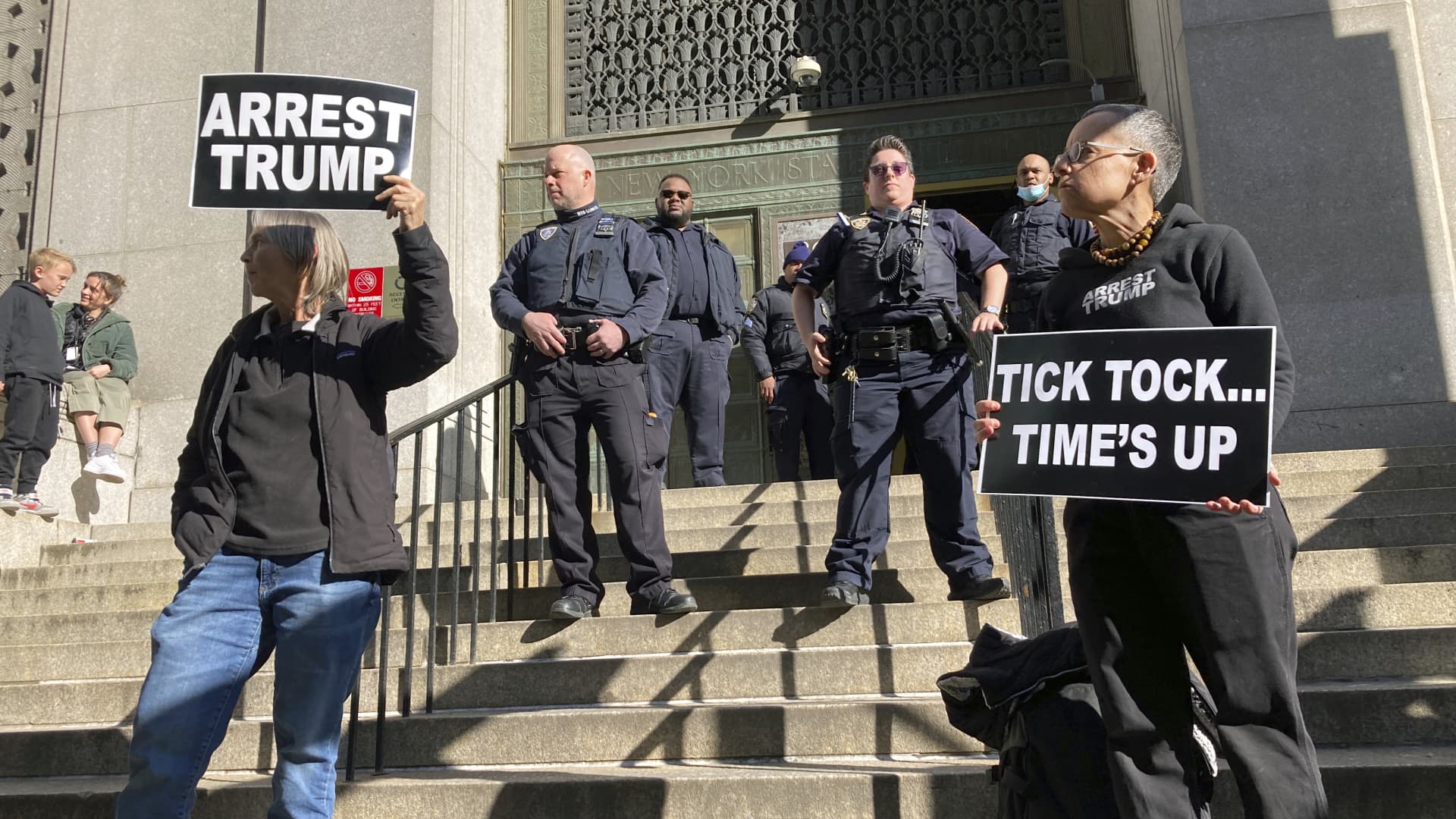 Members of the news media, protesters and New York State Court Officers are at the front steps of 80 Centre Street on Monday, March 20, 2023, in New York City, where a grand jury is investigating Donald Trump over a hush money payment to a porn star.