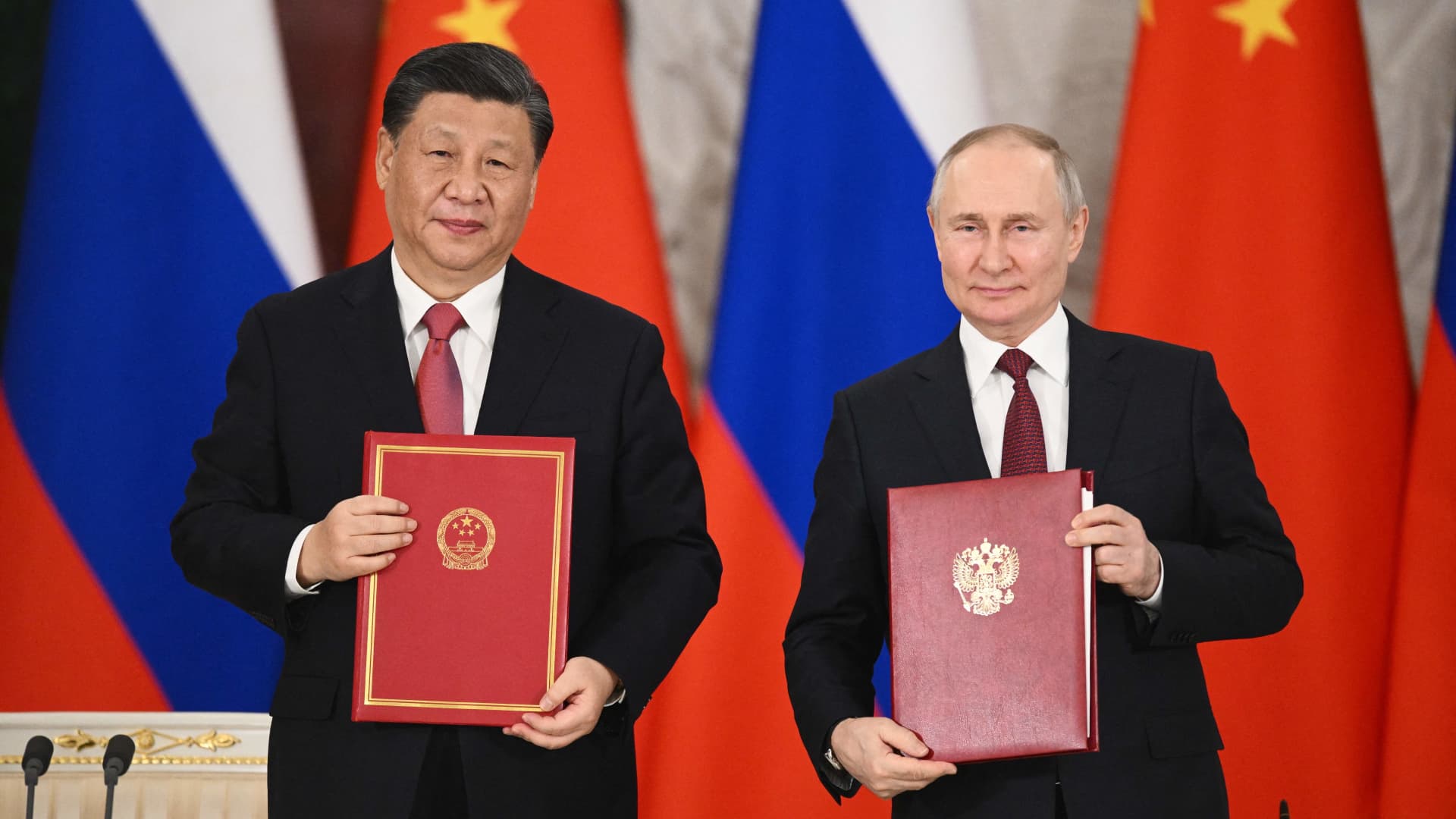 Russian President Vladimir Putin and China's President Xi Jinping shake hands during a signing ceremony following their talks at the Kremlin in Moscow on March 21, 2023. 