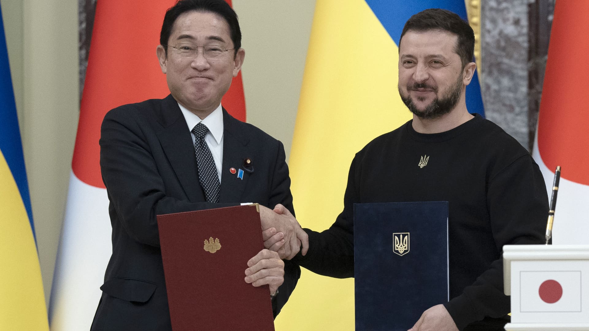 Fumio Kishida, Japan's prime minister, left, and Volodymyr Zelenskiy, Ukraine's president, shake hands during a news conference at the president's residence, known as Mariinsky Palace, in Kyiv, Ukraine, on Tuesday, March 21, 2023.