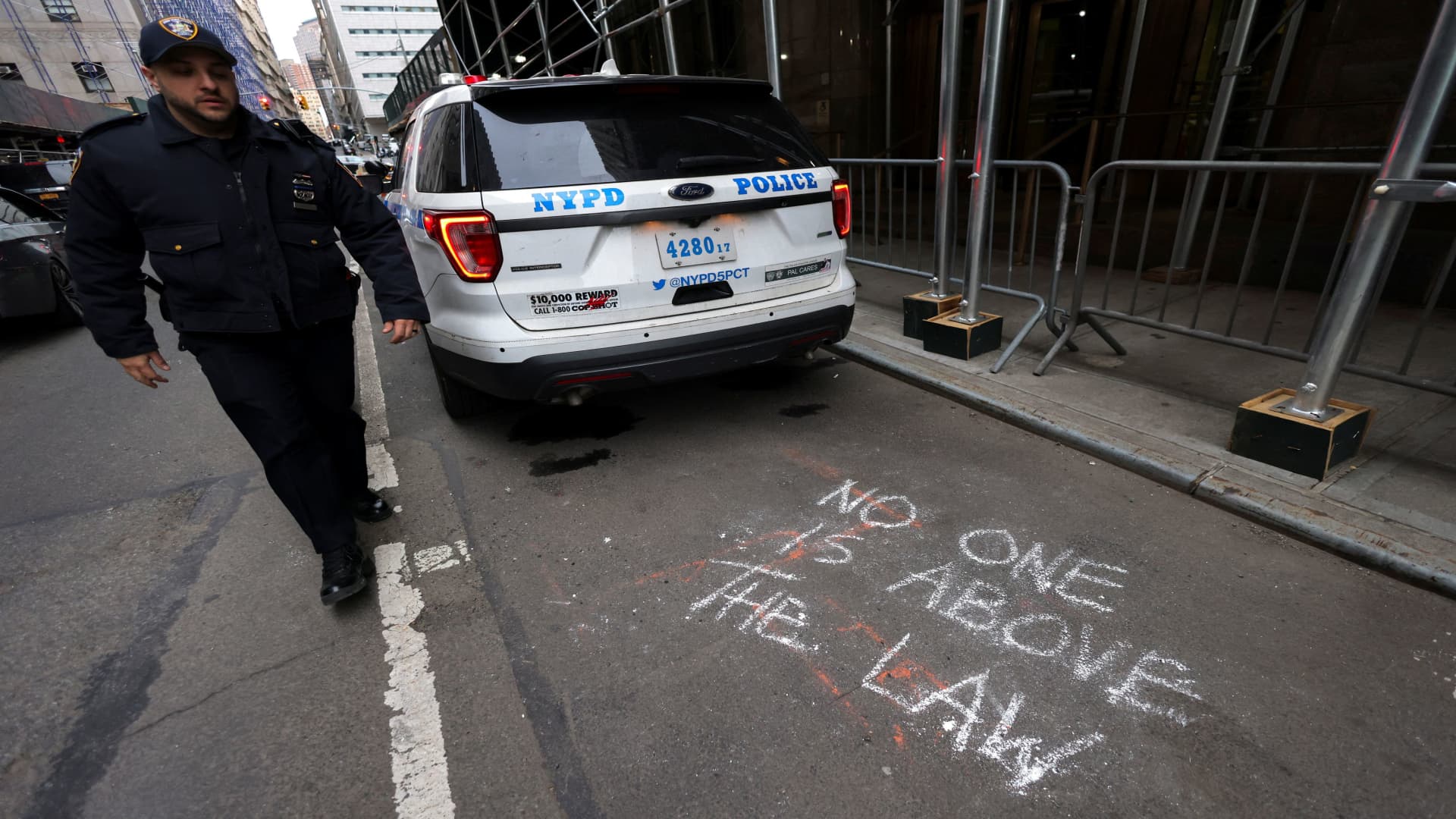 A chalk graffitti is seen on a road outside offices of the District Attorney, after a message was posted on the Truth Social account of former U.S. President Donald Trump stating that he had expected to be arrested, and called on his supporters to protest, in New York City, U.S. March 22, 2023. 