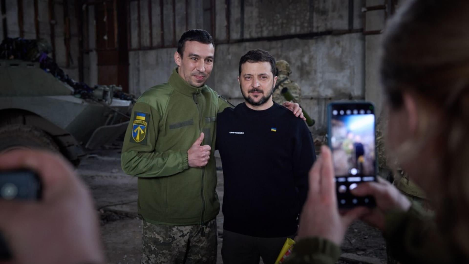 Ukrainian President Volodymyr Zelenskyy (R) poses for a photo with a Ukrainian soldier during his visit to Bakhmut frontline amid Russia-Ukraine war in Donetsk region, Bakhmut, Ukraine on March 22, 2023. 