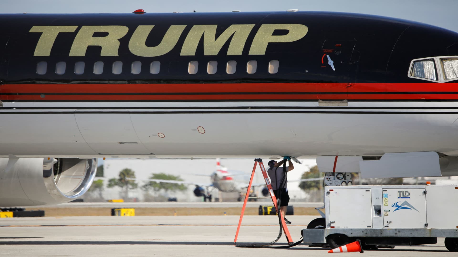 A man inspects a plane of former U.S. President Donald Trump at the Palm Beach International Airport, days after he posted a message on his Truth Social account saying that he had expected to be arrested, and called on his supporters to protest, in West Palm Beach, Florida, U.S. March 22, 2023. 