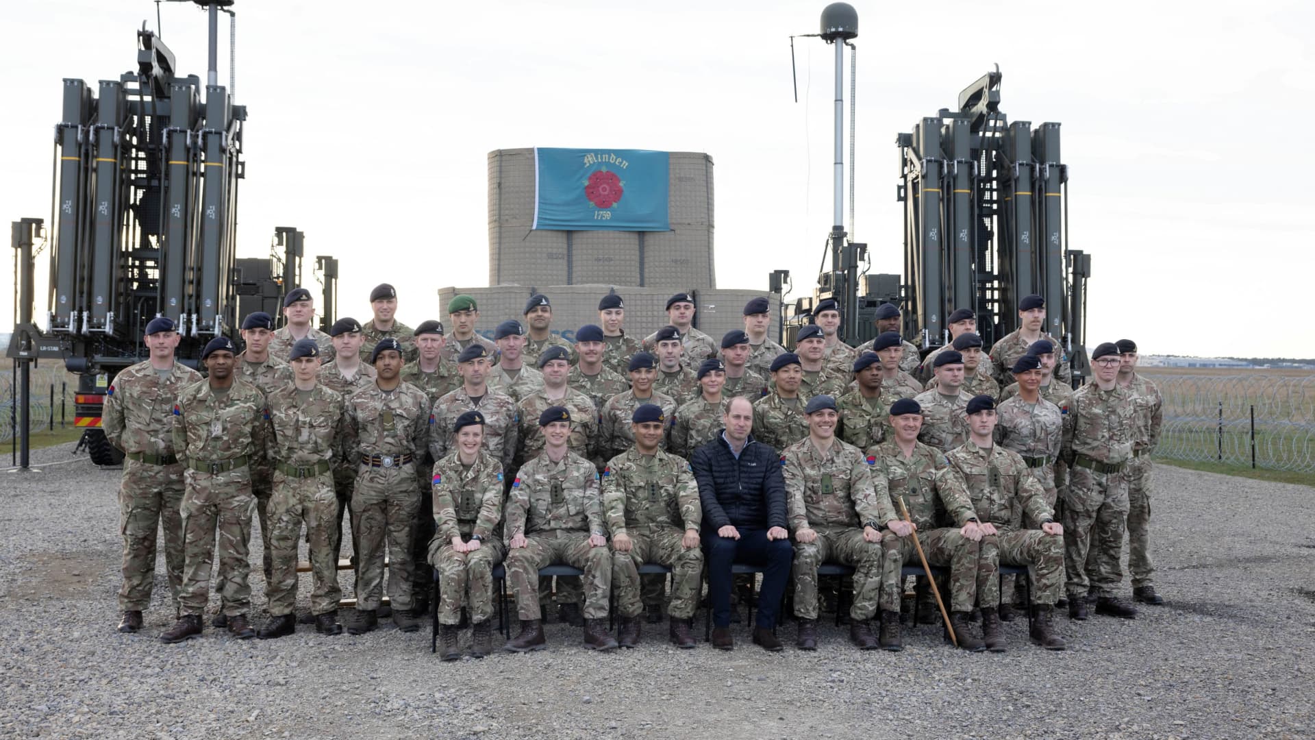 William Prince of Wales sits for a group photograph while visiting British Armed forces to hear how the troops have been working with Polish Armed Forces delivering support for Ukraine, mainly Royal Artillery troops, in Rzeszow, Poland, March 22, 2023. Ian Vogler/Pool via REUTERS