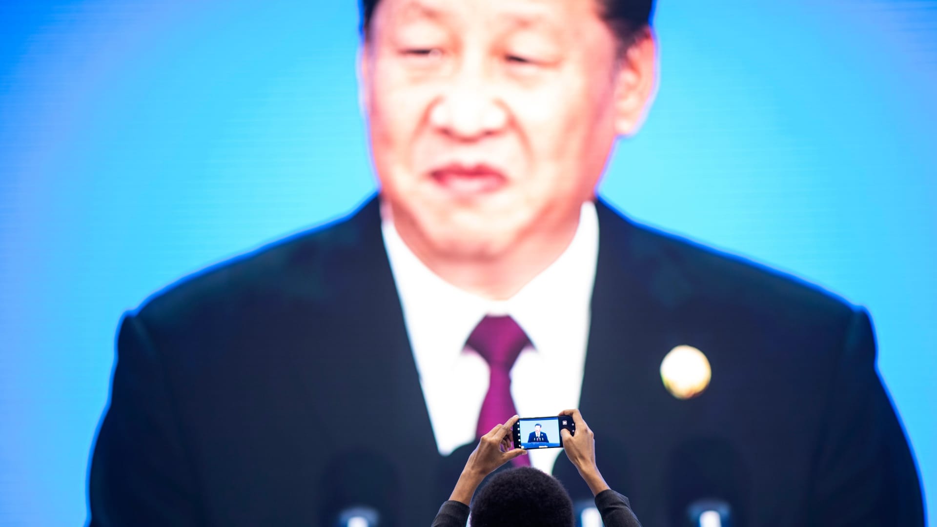 China's President Xi Jinping is seen on a big screen in Shanghai on November 5, 2018.