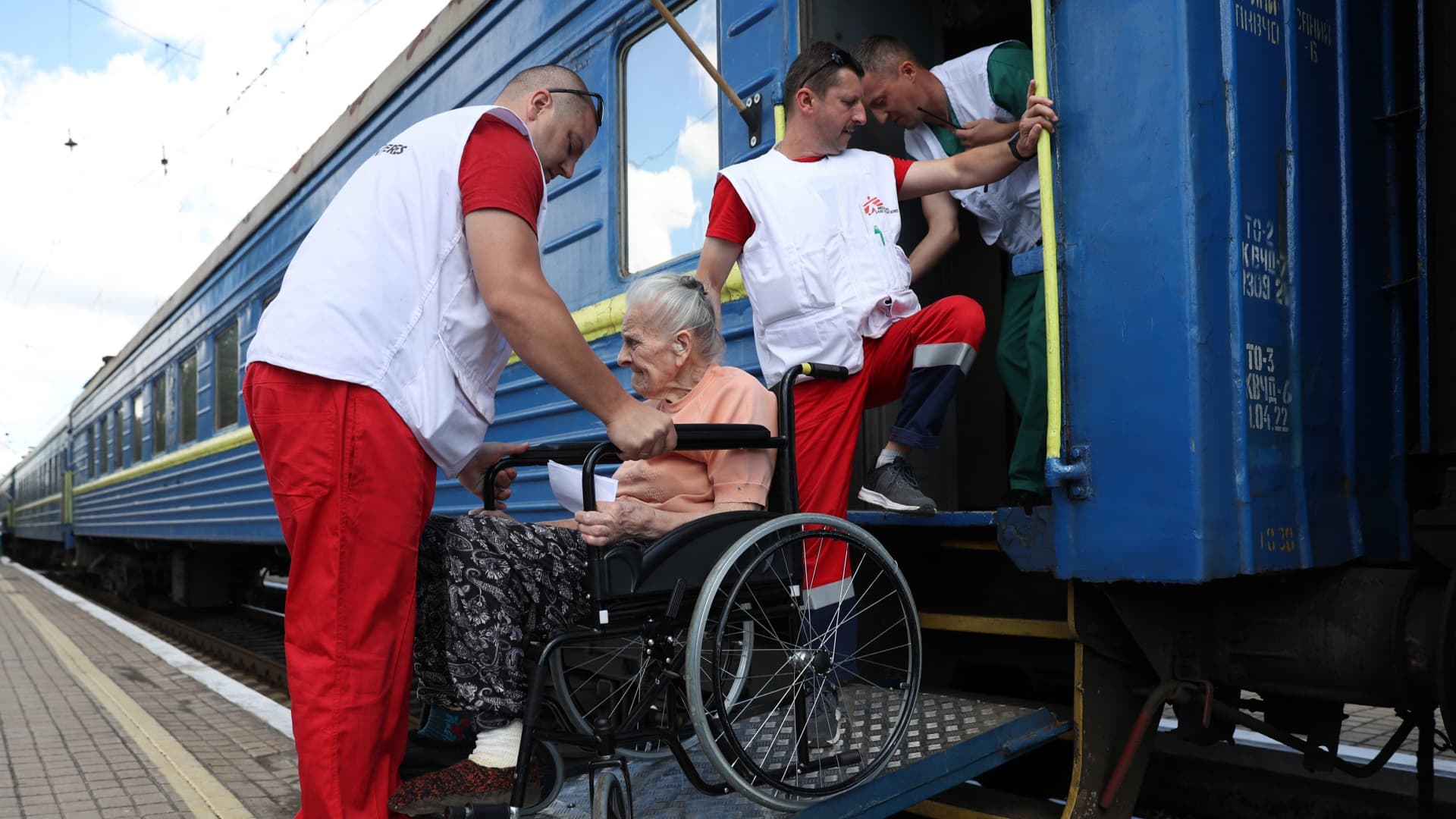 Employees of the Red Cross and Doctors Without Borders organisations take part in the evacuation by train of pensioners with heavy diseases from different settlements located close to the front line, at the railway station in Pokrovsk, Donetsk region, on July 18, 2022.