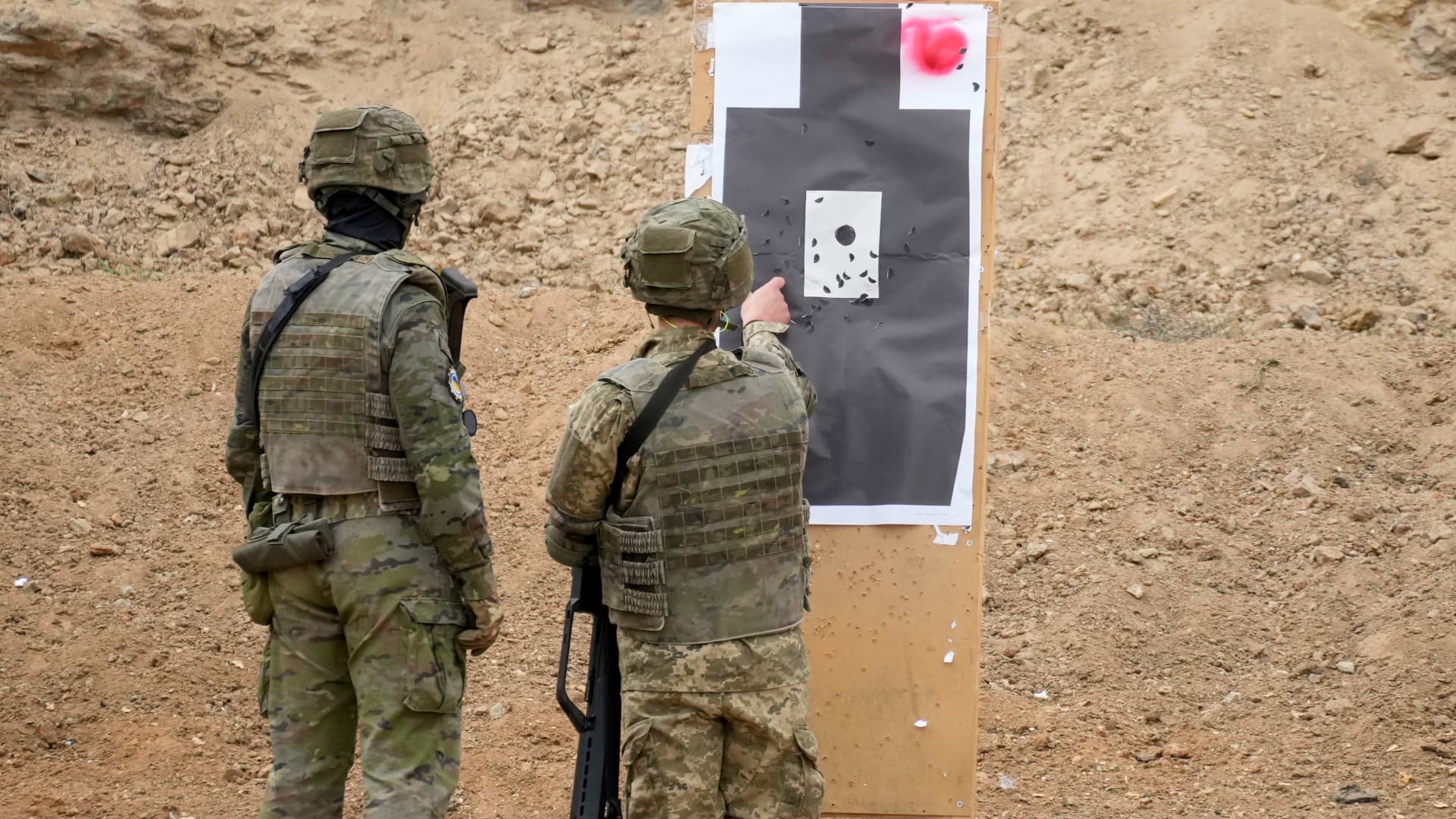 Ukrainian military personnel inspect a target during a firing range exercise, conducted by the Spanish military, at the Toledo infantry academy in Toledo, Spain, on Friday, March 24, 2023. 