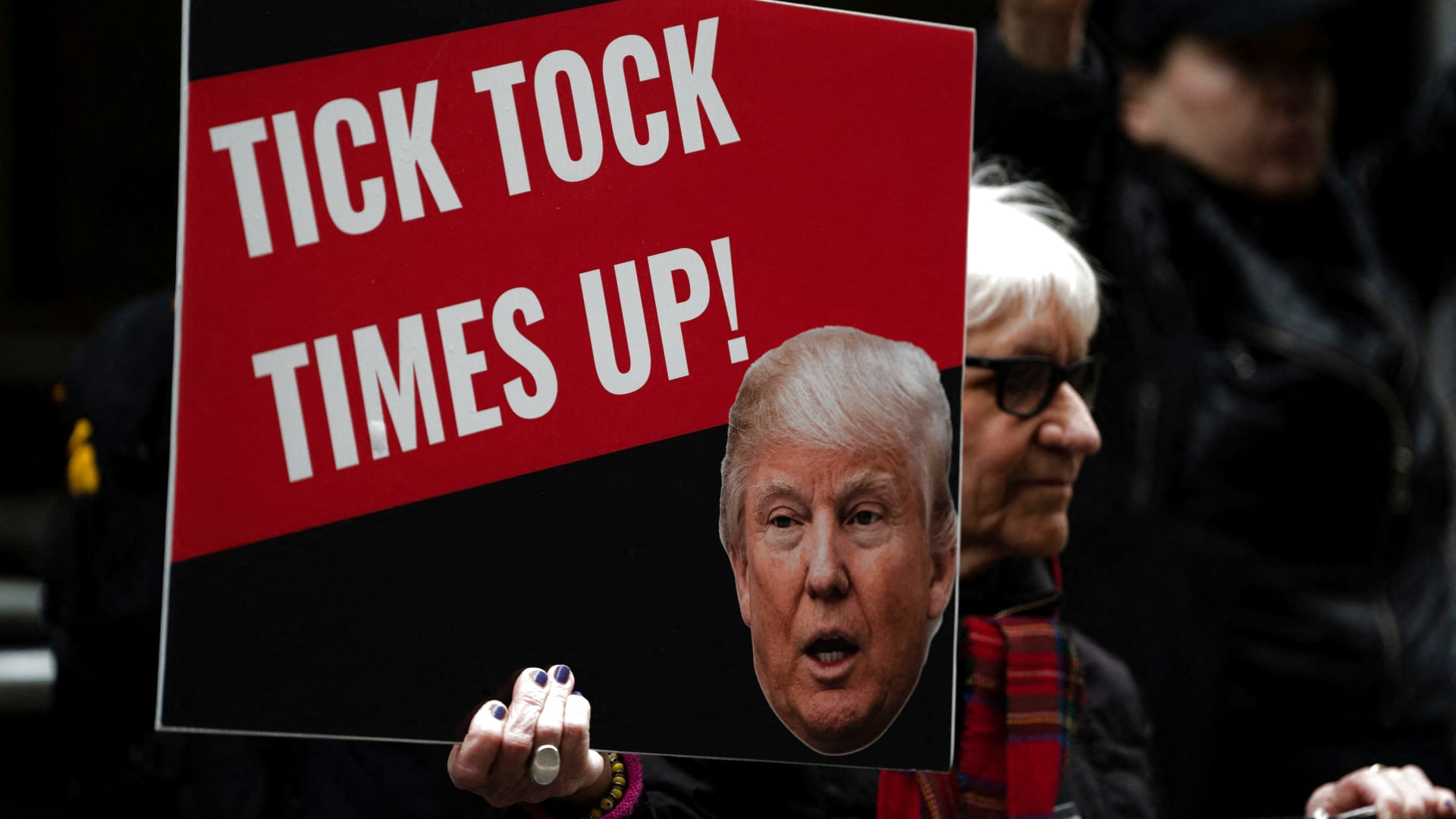An anti-Trump protestor holds a placard outside the District Attorney's office, as Manhattan District Attorney Alvin Bragg's office investigates $130,000 paid in the final weeks of former U.S. President Donald Trump's 2016 election campaign to Stormy Daniels, a porn star who said she had a sexual encounter with Trump in 2006 when he was married to his current wife Melania, in New York City, U.S. March 24, 2023.
