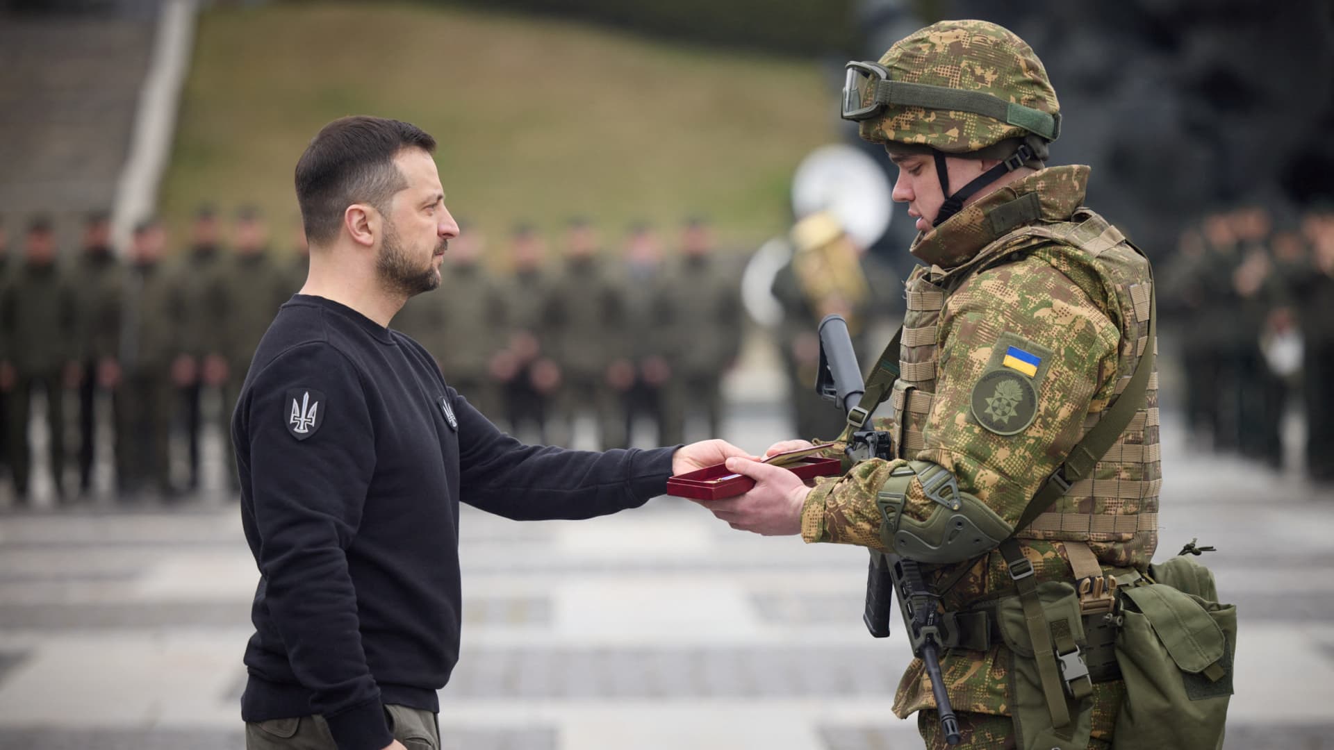 Ukraine's President Volodymyr Zelenskiy awards an officer during a ceremony marking the 9th anniversary of the National Guard of Ukraine, amid Russia's attack on Ukraine, at a compound of the World War II Museum in Kyiv, Ukraine March 24, 2023. 