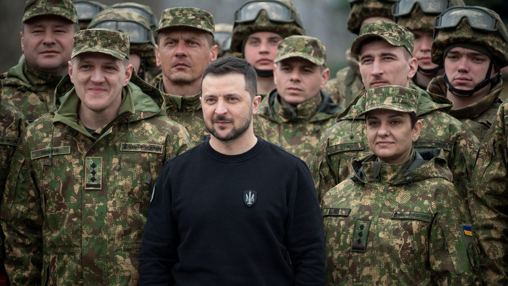 Ukraine's President Volodymyr Zelenskiy poses for a picture with officers during a ceremony marking the 9th anniversary of the National Guard of Ukraine, amid Russia's attack on Ukraine, at a compound of the World War II Museum in Kyiv, Ukraine March 24, 2023. 