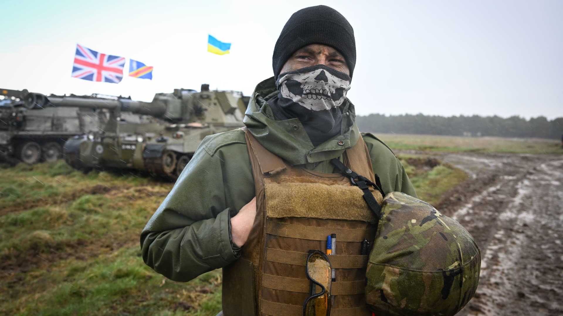 A Ukrainian soldier is seen with flags of Ukraine and the United Kingdom during their final training, on March 24, 2023 in South West, England. 