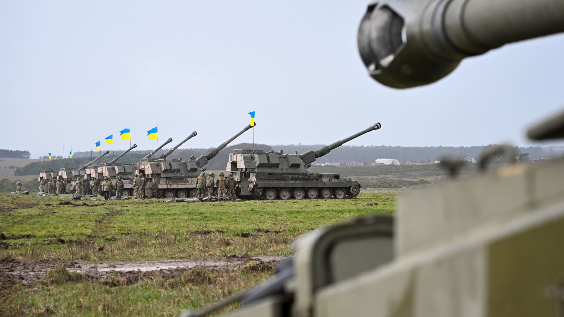 AS90 155mm self-propelled guns with Ukrainian flags are seen during final training, on March 24, 2023 in South West, England. 