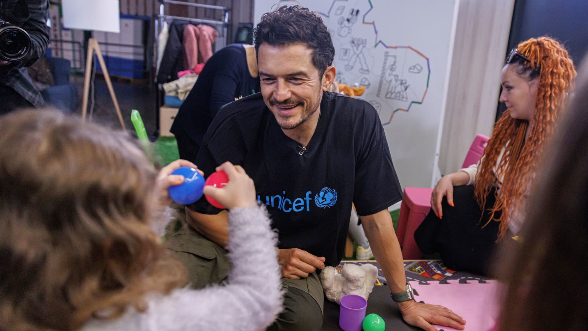 Actor and UNICEF Goodwill Ambassador Orlando Bloom plays with children in the UNICEF Spilno Child Spot at a metro station in Kyiv, Ukraine March 25, 2023 in this handout image. 