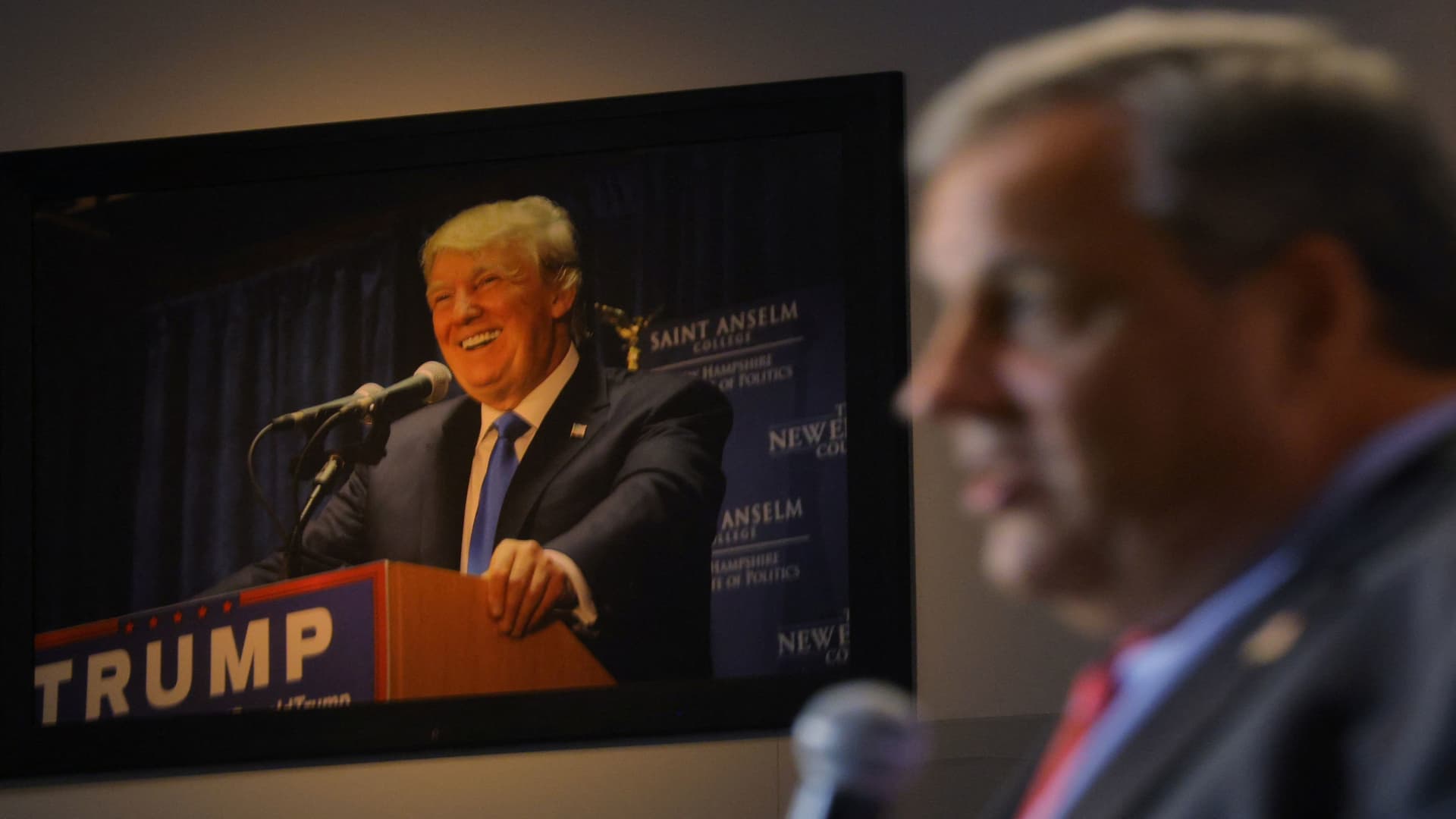 A photograph of former U.S. President Donald Trump hangs on the wall as former New Jersey Governor Chris Christie speaks at the Institute of Politics at St. Anselm College in Manchester, New Hampshire, U.S., March 27, 2023. 