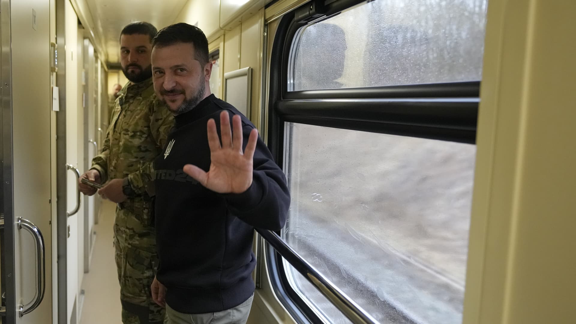 Ukrainian President Volodymyr Zelenskyy waves goodbye after an interview with The Associated Press on a train traveling from the Sumy region to Kyiv, Ukraine, Tuesday March 28, 2023.