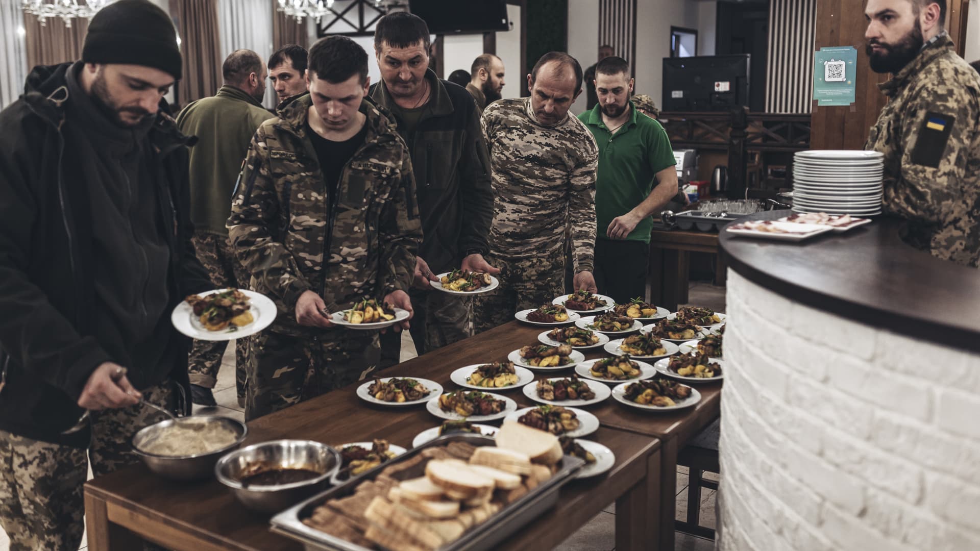 EASTERN UKRAINE, UKRAINE - MARCH 20: Ukrainian soldiers eat dinner after a small concert held for Ukrainian Army at a rehabilitation center in eastern Ukraine as Russia-Ukraine war continues on March 20, 2023. (Photo by Diego Herrera Carcedo/Anadolu Agency via Getty Images)