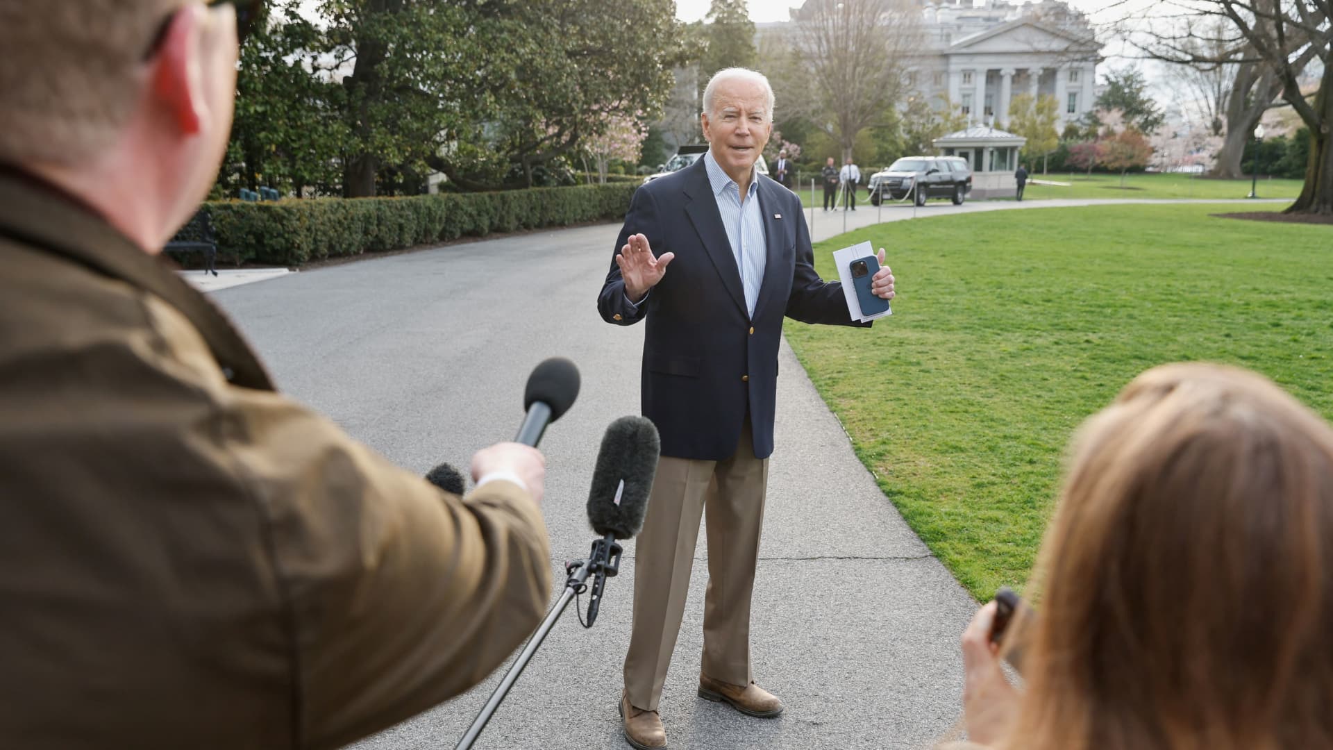 Members of the media ask questions to U.S. President Joe Biden as he walks to the Marine One helicopter to depart for travel to Mississippi to view tornado damage, from the White House in Washington, U.S., March 31, 2023. 