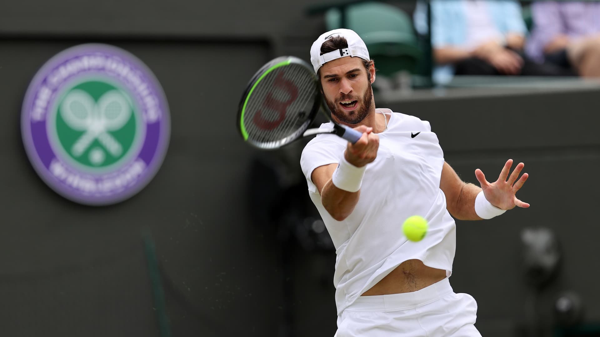 Karen Khachanov of Russia plays a backhand during his men's Singles Quarter Final match against Denis Shapovalov of Canada on Day Nine of The Championships - Wimbledon 2021 at All England Lawn Tennis and Croquet Club on July 07, 2021 in London, England.