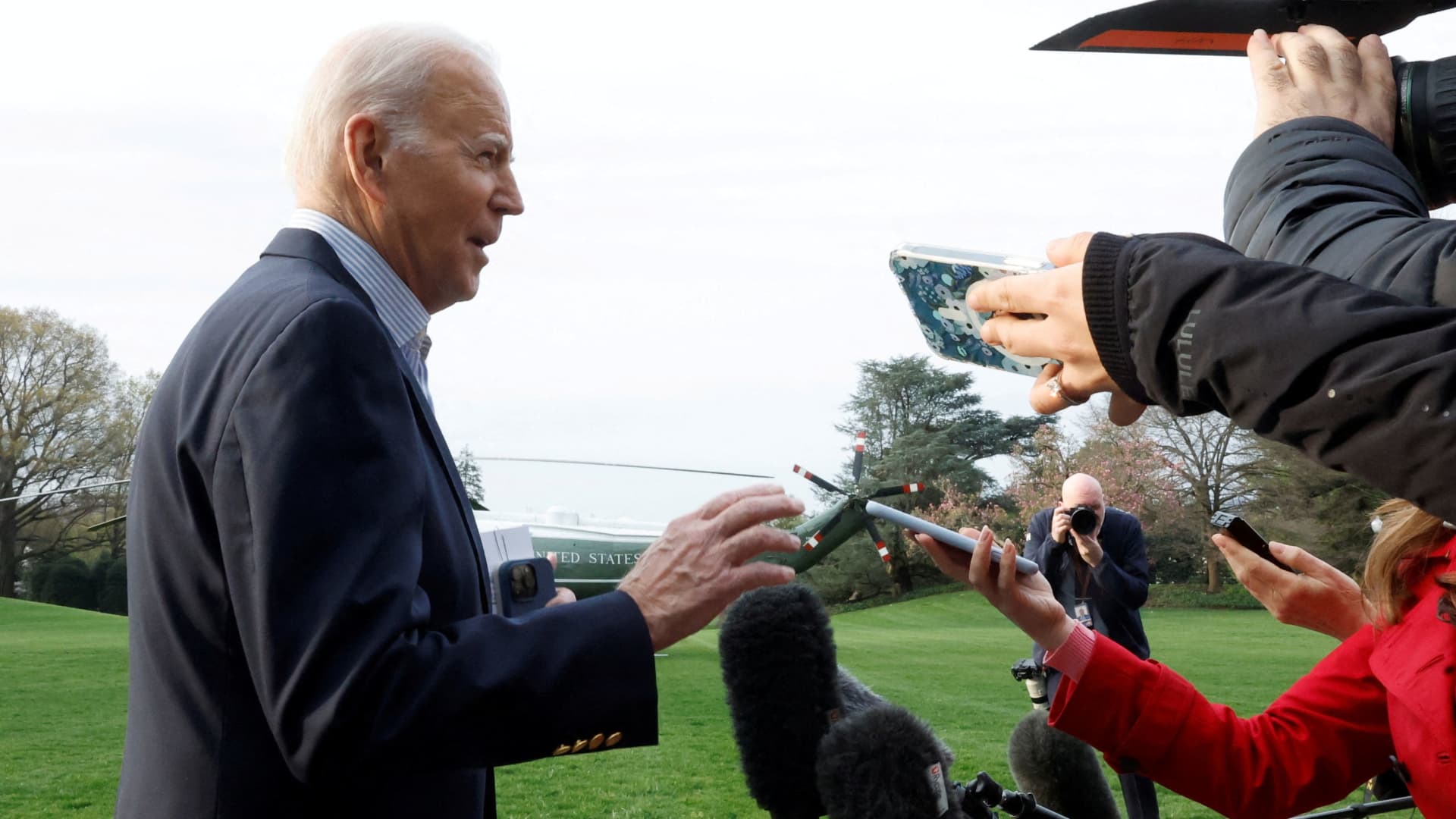 Members of the media ask questions to U.S. President Joe Biden as he walks to the Marine One helicopter to depart for travel to Mississippi to view tornado damage, from the White House in Washington, U.S., March 31, 2023. 