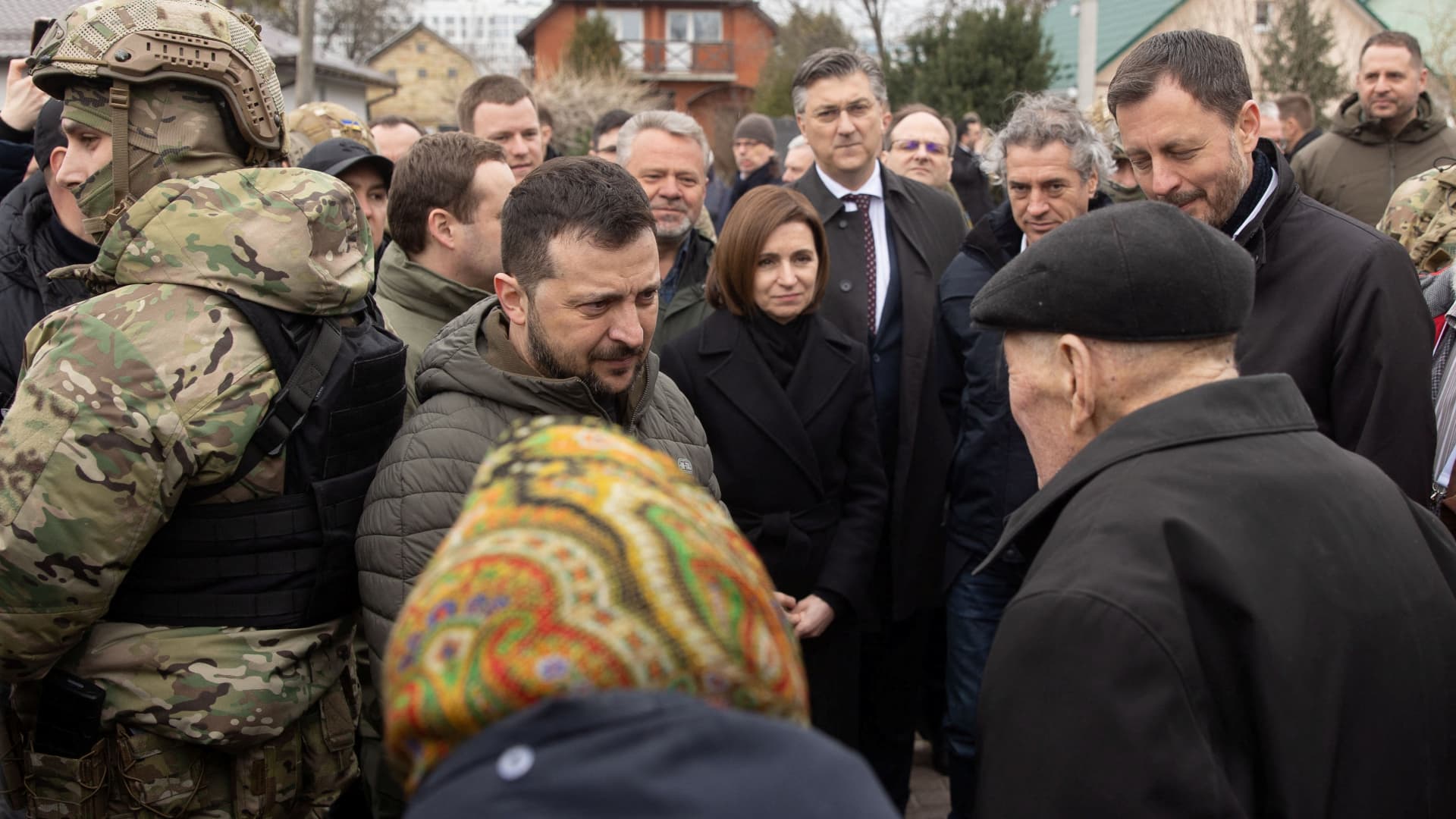 Slovenia's Prime Minister Robert Golob, Ukraine's President Volodymyr Zelenskiy, Moldovan President Maia Sandu, Croatian Prime Minister Andrej Plenkovic and Slovakian Prime Minister Eduard Heger speak with local residents as they visit the town of Bucha marking the first anniversary of its liberation, amid Russia's attack on Ukraine, outside of Kyiv, Ukraine March 31, 2023. 