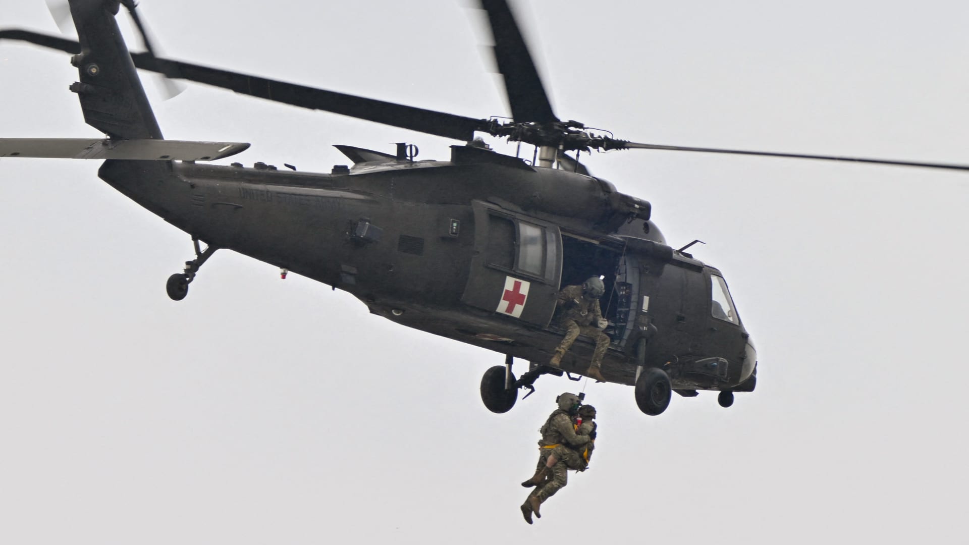 A medevac Black Hawk helicopter flies during a demonstration as part of the rotation of US troops of the US Army 101 Airborne division at Mihail Kogalniceanu Air Base (RoAF 57th Air Base) near Constanta, Romania on March 31, 2023. 