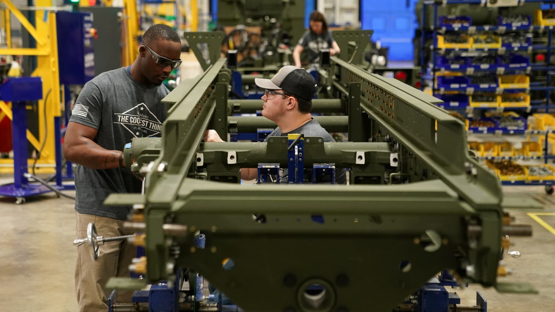 Technicians work on a HIMARS (High Mobility Artillery Rocket System) missile launcher chassis at Lockheed Martin Camden Operations in Camden, Arkansas, February 27, 2023.