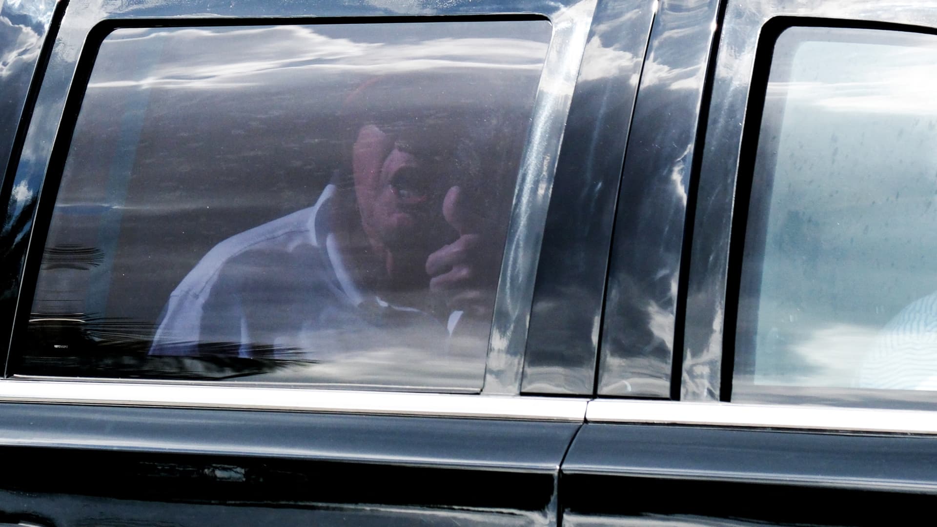 Former U.S. President Donald Trump gestures from his motorcade as he leaves his Trump International Golf Club after his indictment by a Manhattan grand jury following a probe into hush money paid to porn star Stormy Daniels, in West Palm Beach, Florida, U.S., April 1, 2023. 