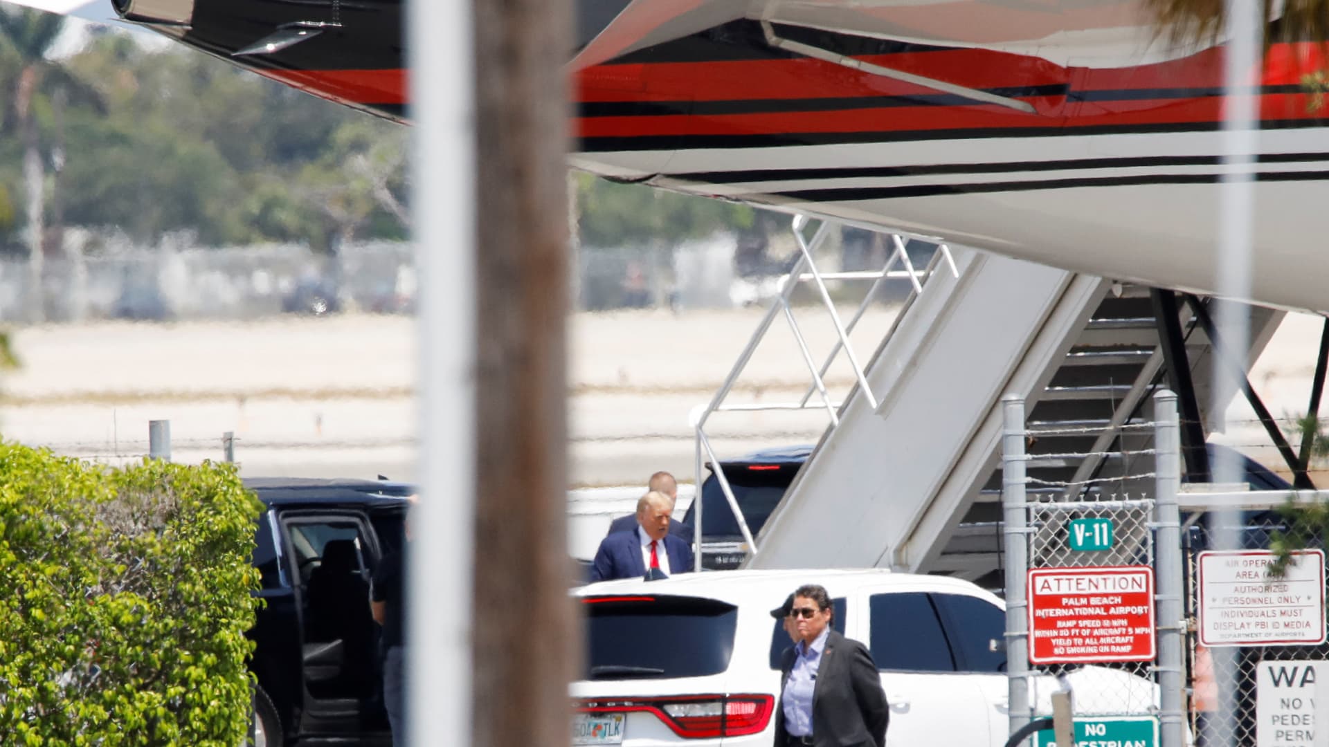 Former U.S. President Donald Trump stands near his plane, at the Palm Beach International Airport, after former his indictment by a Manhattan grand jury following a probe into hush money paid to porn star Stormy Daniels, in West Palm Beach, Florida, April 3, 2023.